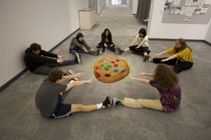 Team Alley Cats bows down to a giant M&M cookie.